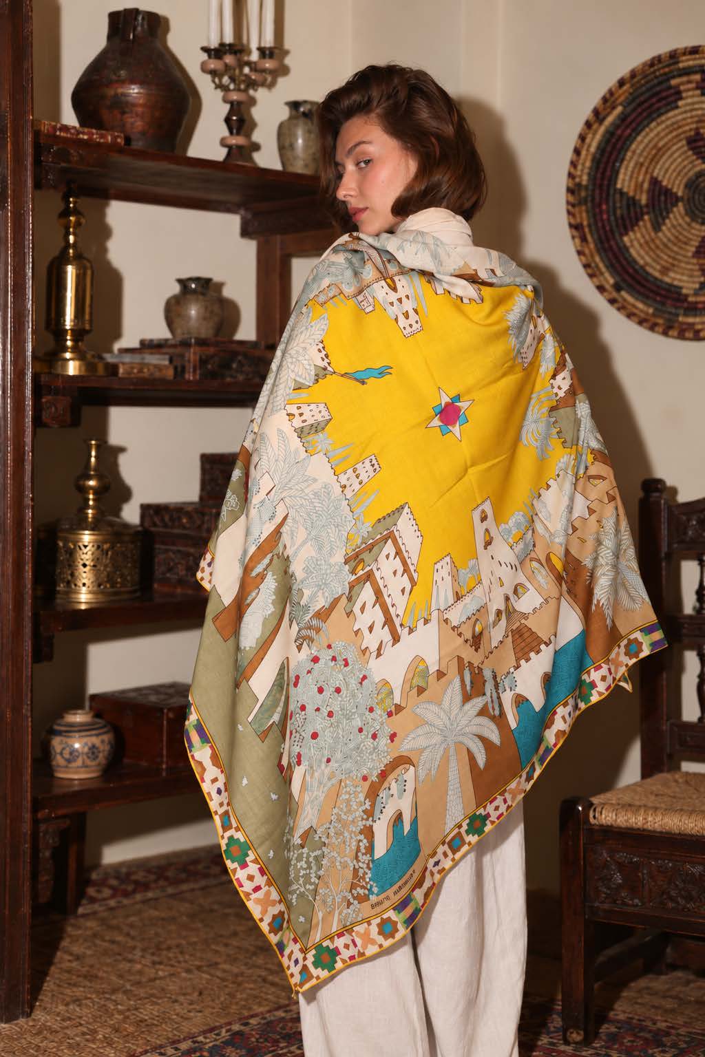 Model in the yellow Oasis Citadel shawl in an oriental interior