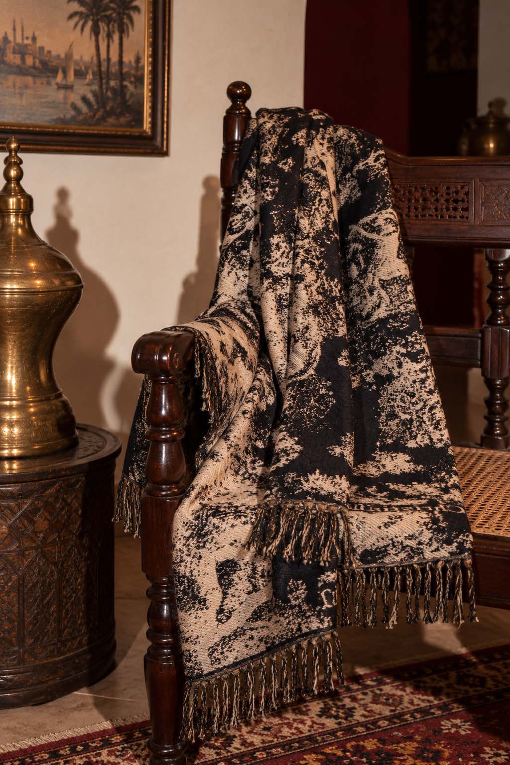 Toile Noir wrap draped on a chair